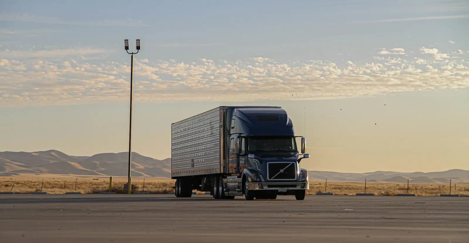 Dark truck on a road in daylight